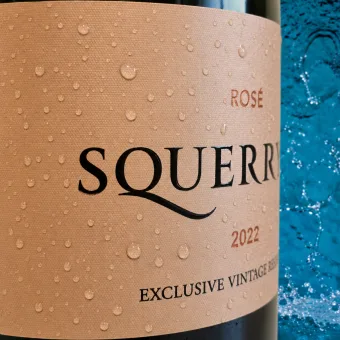 Close-up of custom wine label printing with metallic hot foil, raised screen printing and ultra matt varnish on a rosé magnum bottle